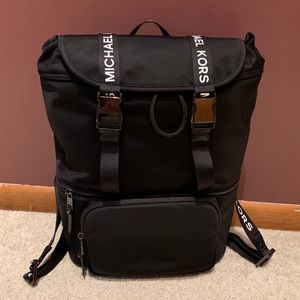 Large flap MK backpack offers welcome